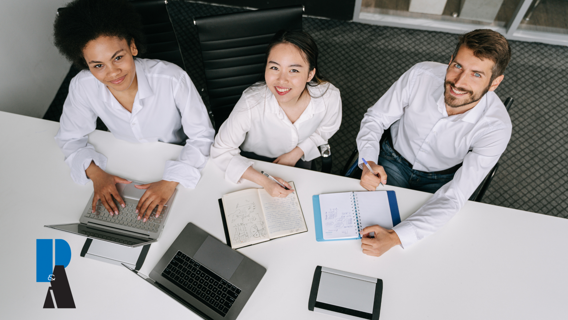 Medicare insurance agents working together on laptops and notes to build a successful Medicare agent portfolio